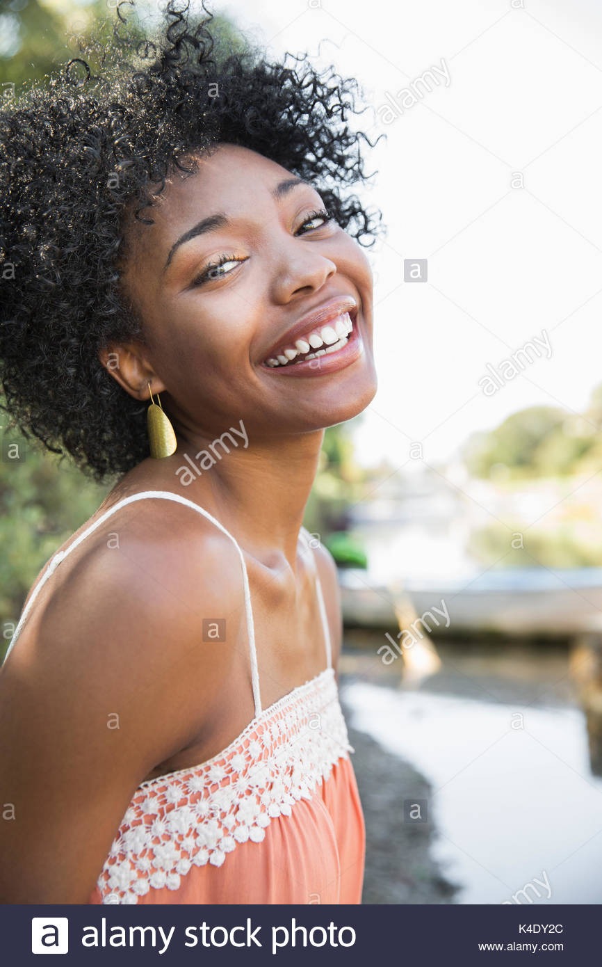 Portrait laughing young African American woman with curly black hair Stock Photo