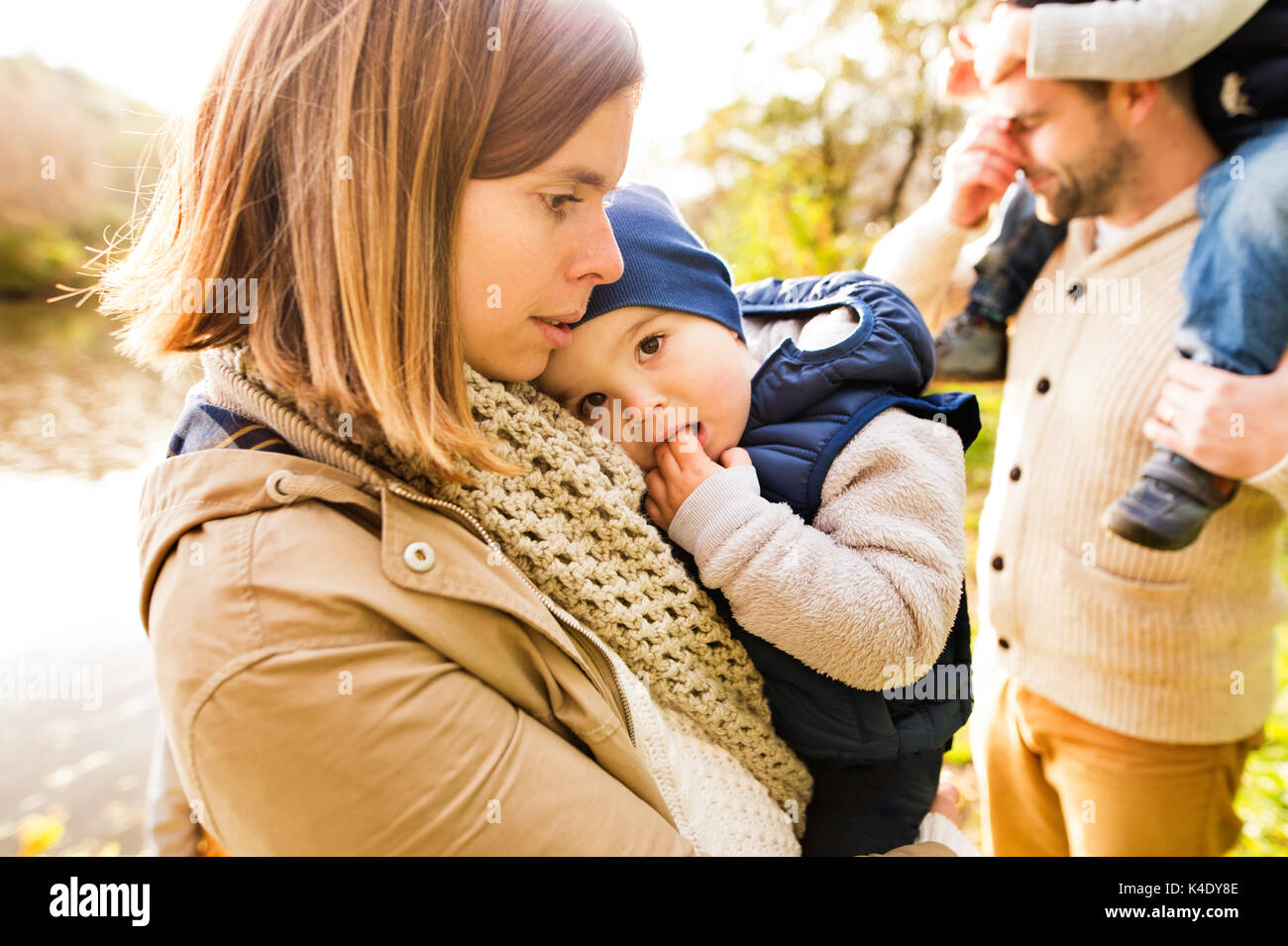 Beautiful young family on a walk in autumn forest Stock Photo - Alamy
