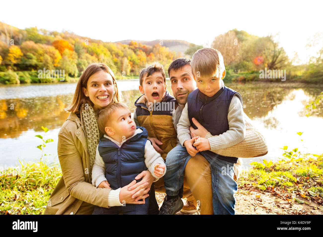 Beautiful young family on a walk in autumn forest Stock Photo - Alamy