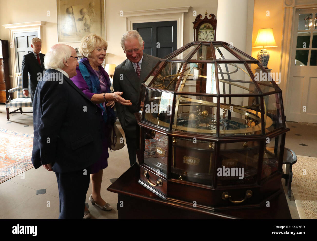 The Prince of Wales, known as the Duke of Rothesay in Scotland, President of Ireland Michael D Higgins and his wife Sabina view the Grand Orrery, an 18th century mechanical model of the solar system, at Dumfries House in East Ayrshire. Stock Photo