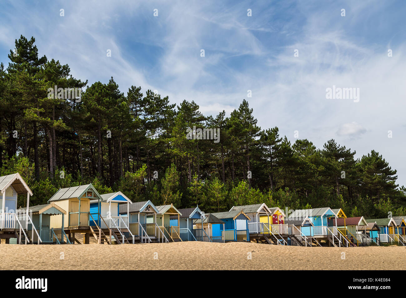 Beach huts line the edge of the beach and fade out of the frame at