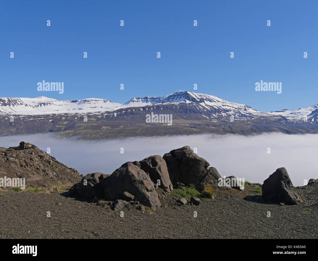 Landscape In The North-East Of Iceland, Wafts Of Mist Over Holmanes Fjord, At Horizon There Are Snowy Mounts Stock Photo