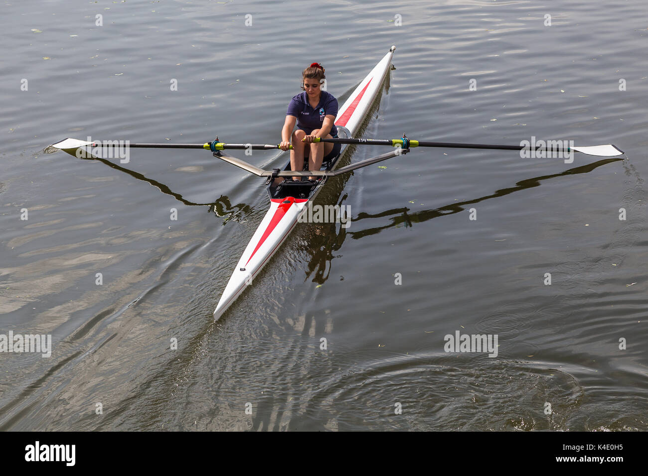 A woman seen rowing a boat through the city of Ely on the Great River
