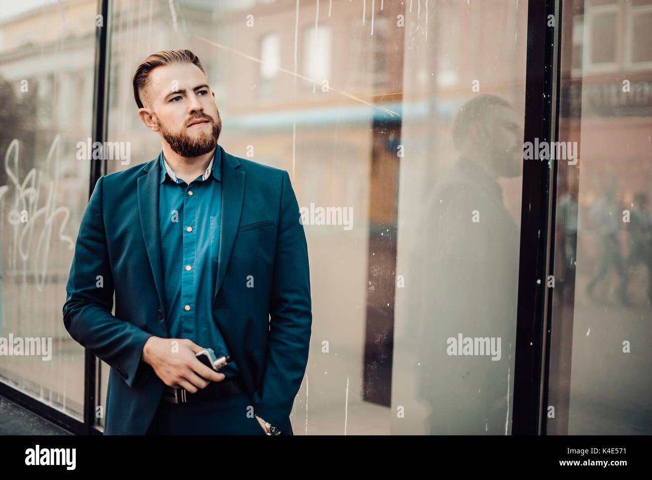 bearded man in the city with the e-cigarette Stock Photo