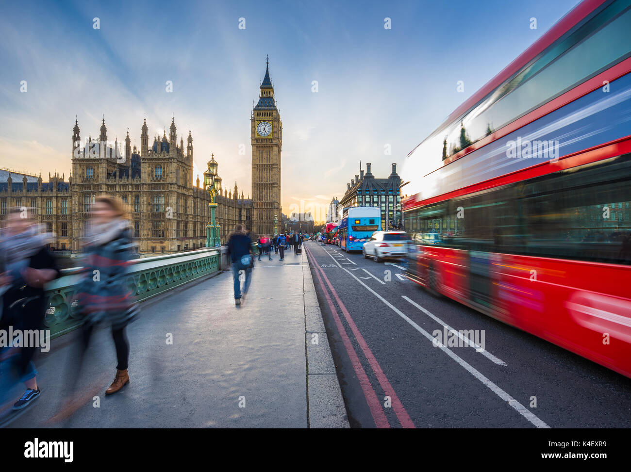 London, England - The iconic Big Ben and the Houses of Parliament with famous red double-decker bus and tourists on the move on Westminster bridge at  Stock Photo