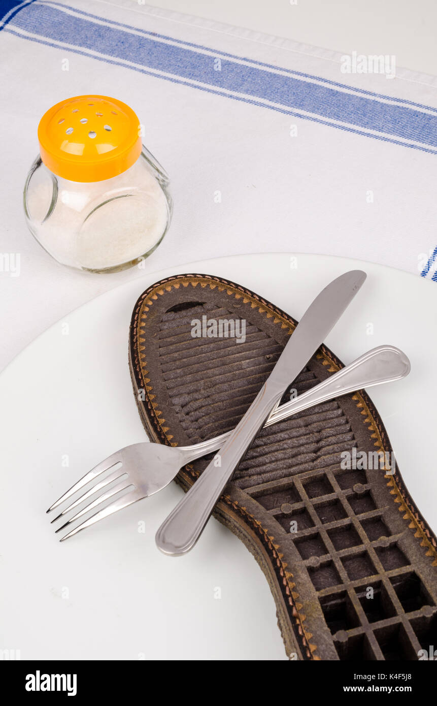 Shoe sole dished, a concept for bad cooking and tough steaks Stock