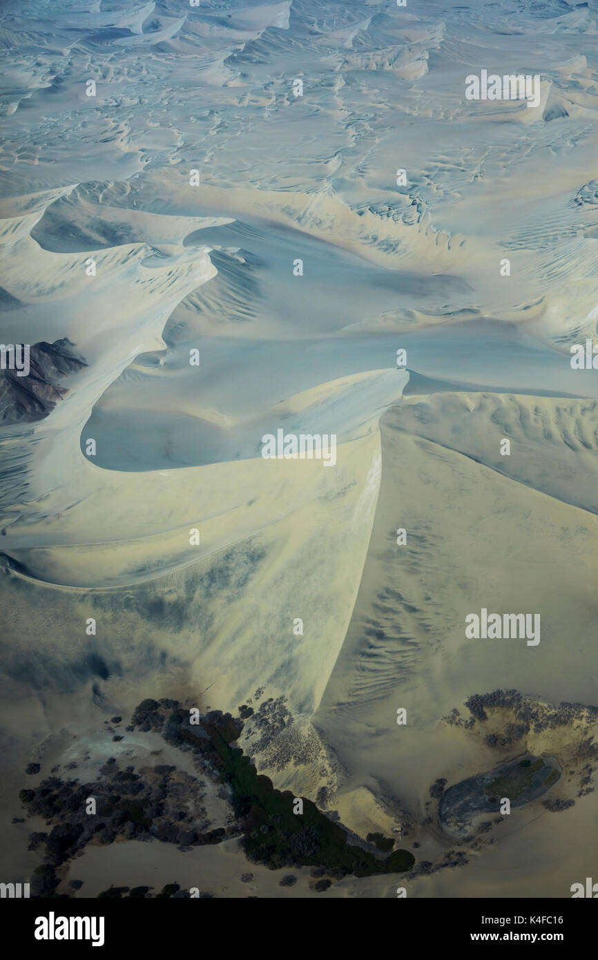Oasis and sand dunes, near Ica, Peru, South America - aerial Stock Photo