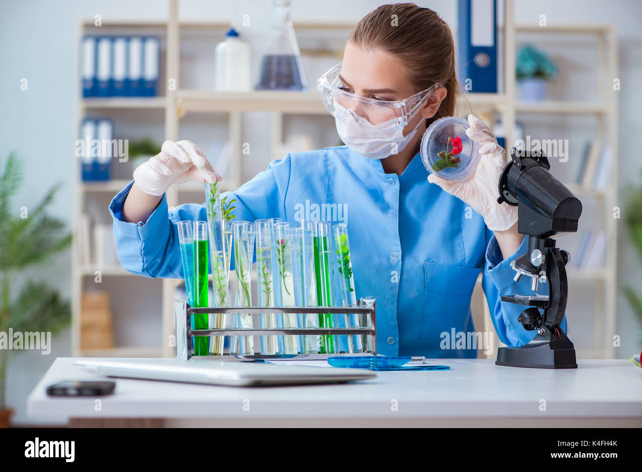 Female scientist researcher conducting an experiment in a laboratory ...