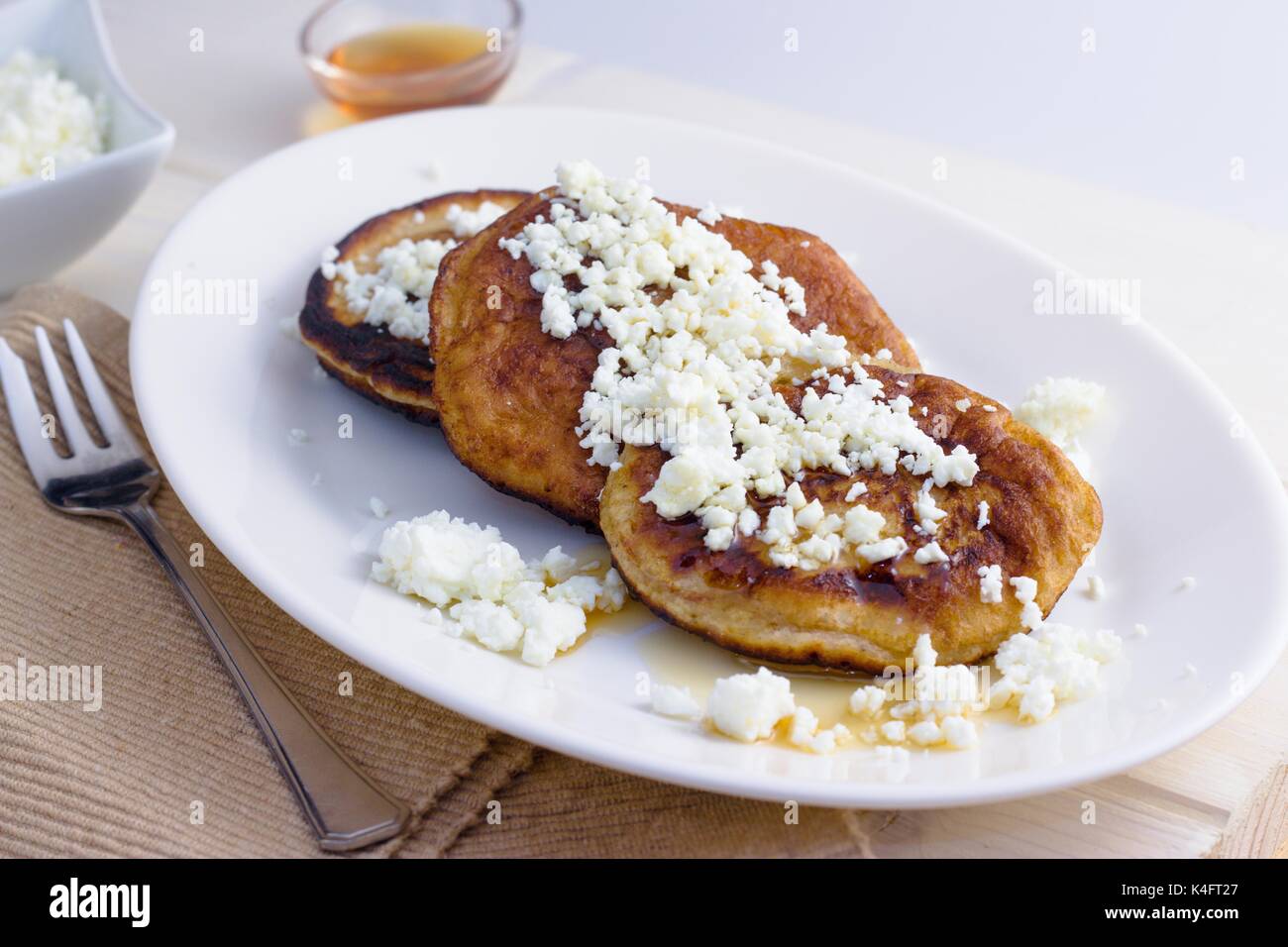 Homemade gluten free pancakes with cottage cheese and honey served on