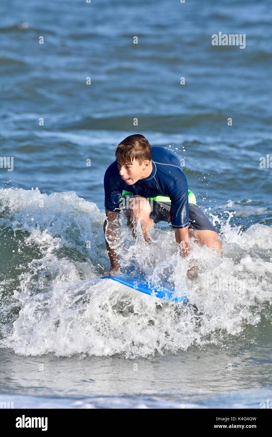 Beach Wave Riding Rafts Surfer riding waves at the beach Stock Photo - Alamy