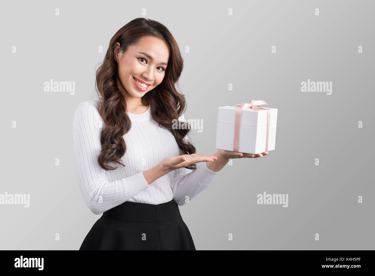 Pretty young asian woman holding gift box Stock Photo
