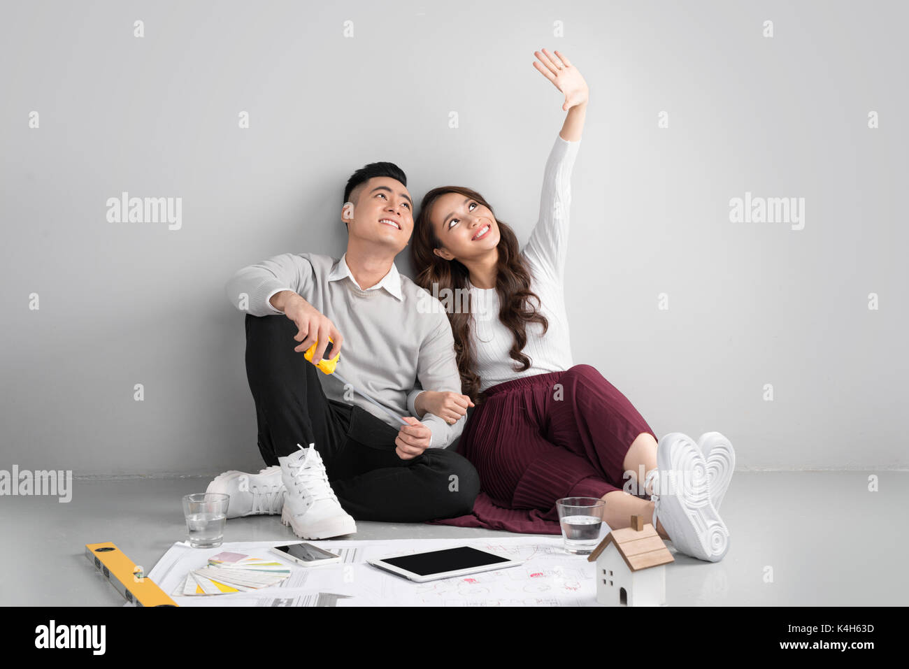 Young happy asian couple thinking hi-res stock photography and images ...