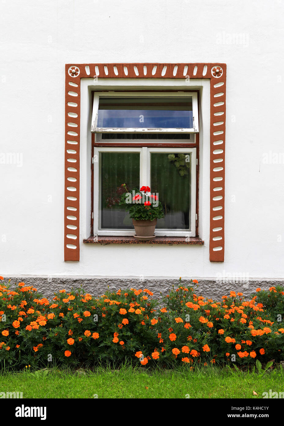 Beautiful country house window with flowers Stock Photo