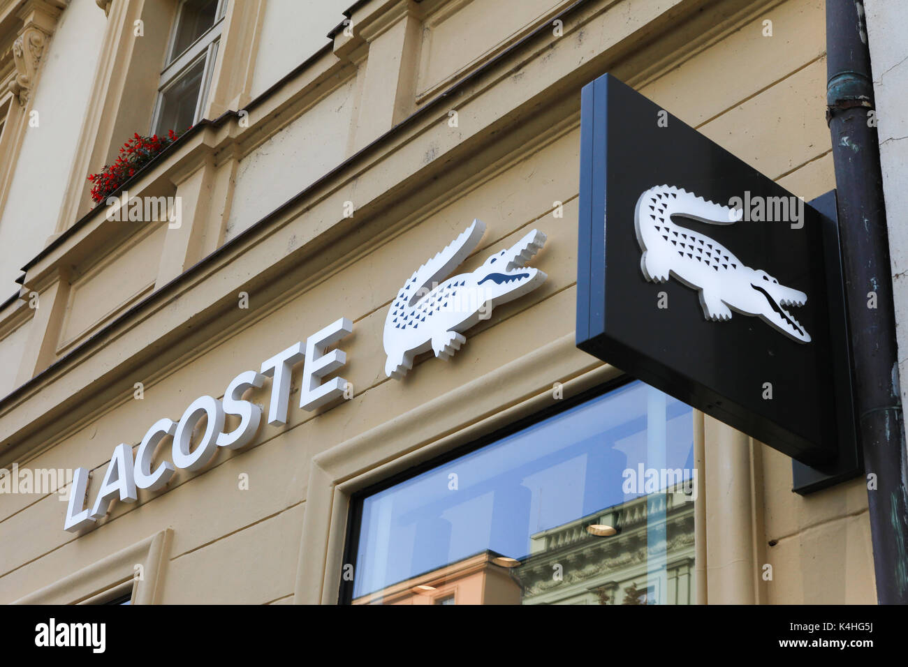 Lacoste sign on a store. Lacoste is a French clothing company that sells high-end clothing, footwear, perfume, leather goods, and most famously polo s Stock Photo