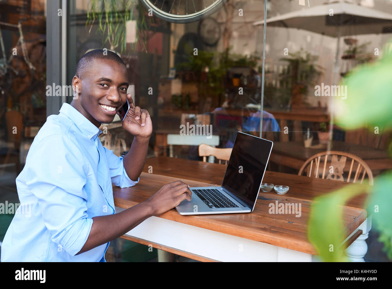 Black man laptop computer outside patio hi-res stock photography and ...