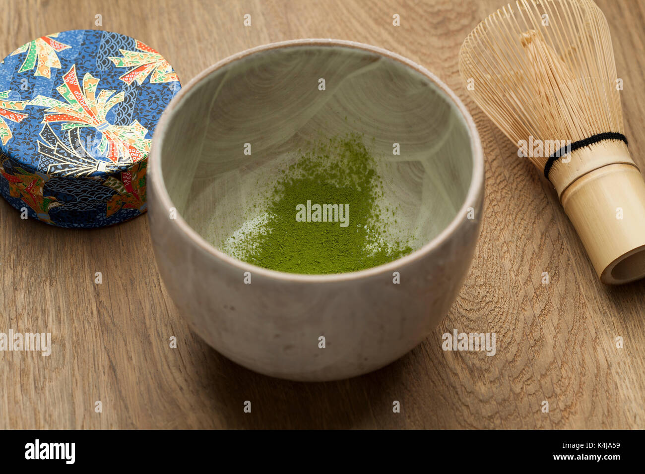 Preparing a bowl of matcha tea with a tea whisk Stock Photo
