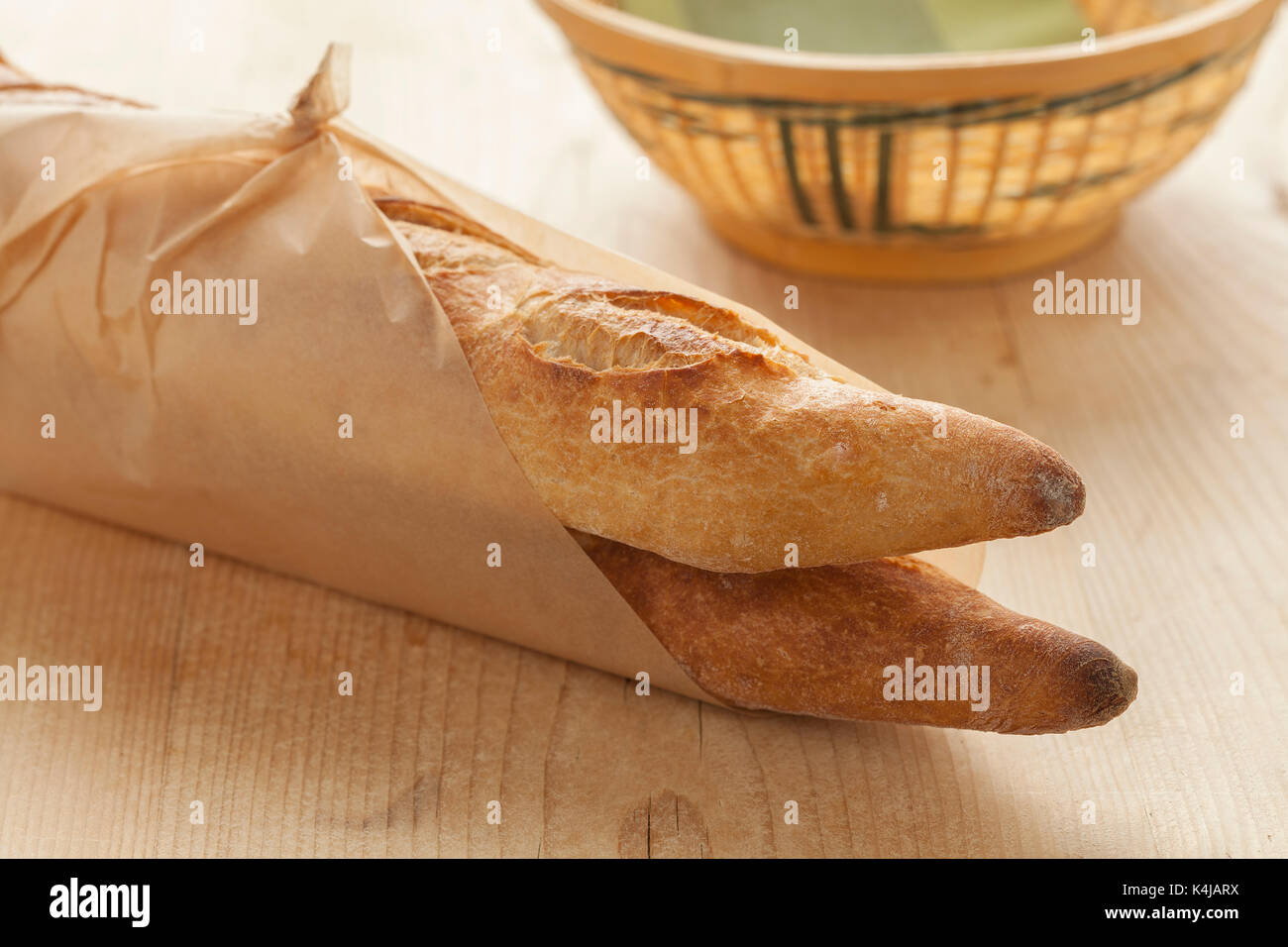 Two French baguettes parisienne wrapped in paper Stock Photo
