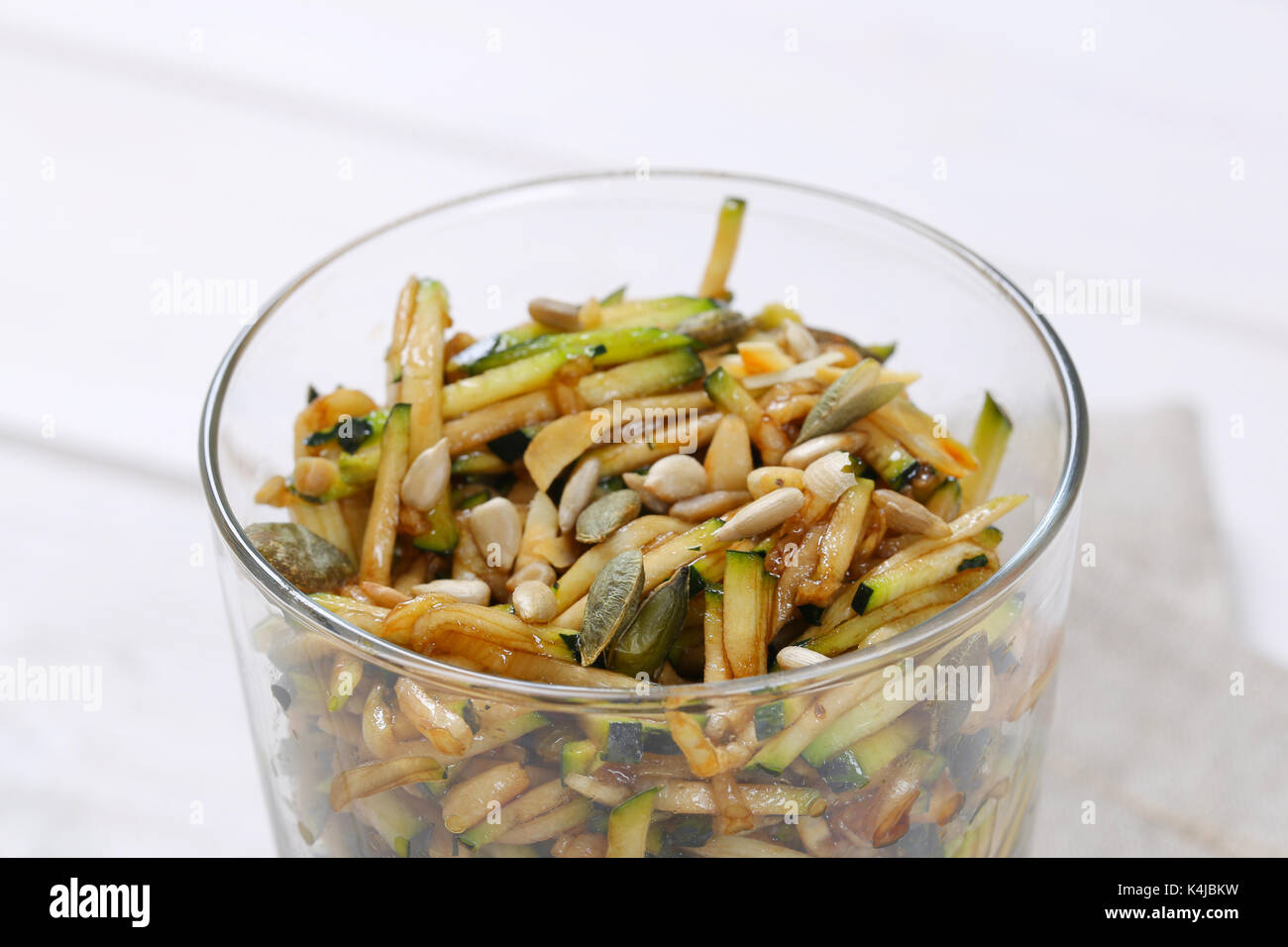 Zucchini salad with pumpkin seeds, sunflower seeds and pine nuts Stock Photo