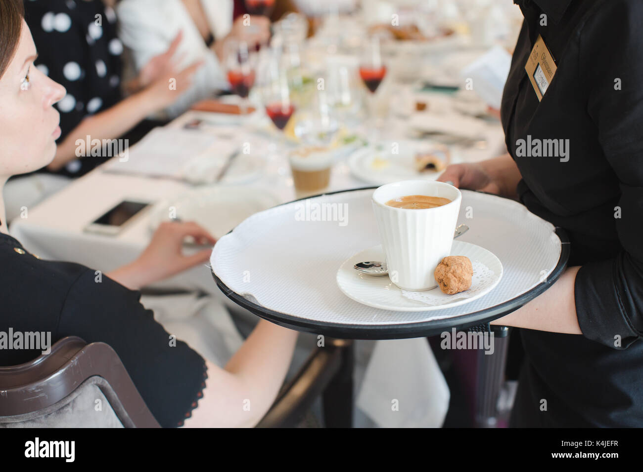 Crop waiter with coffee on tray taking order Stock Photo