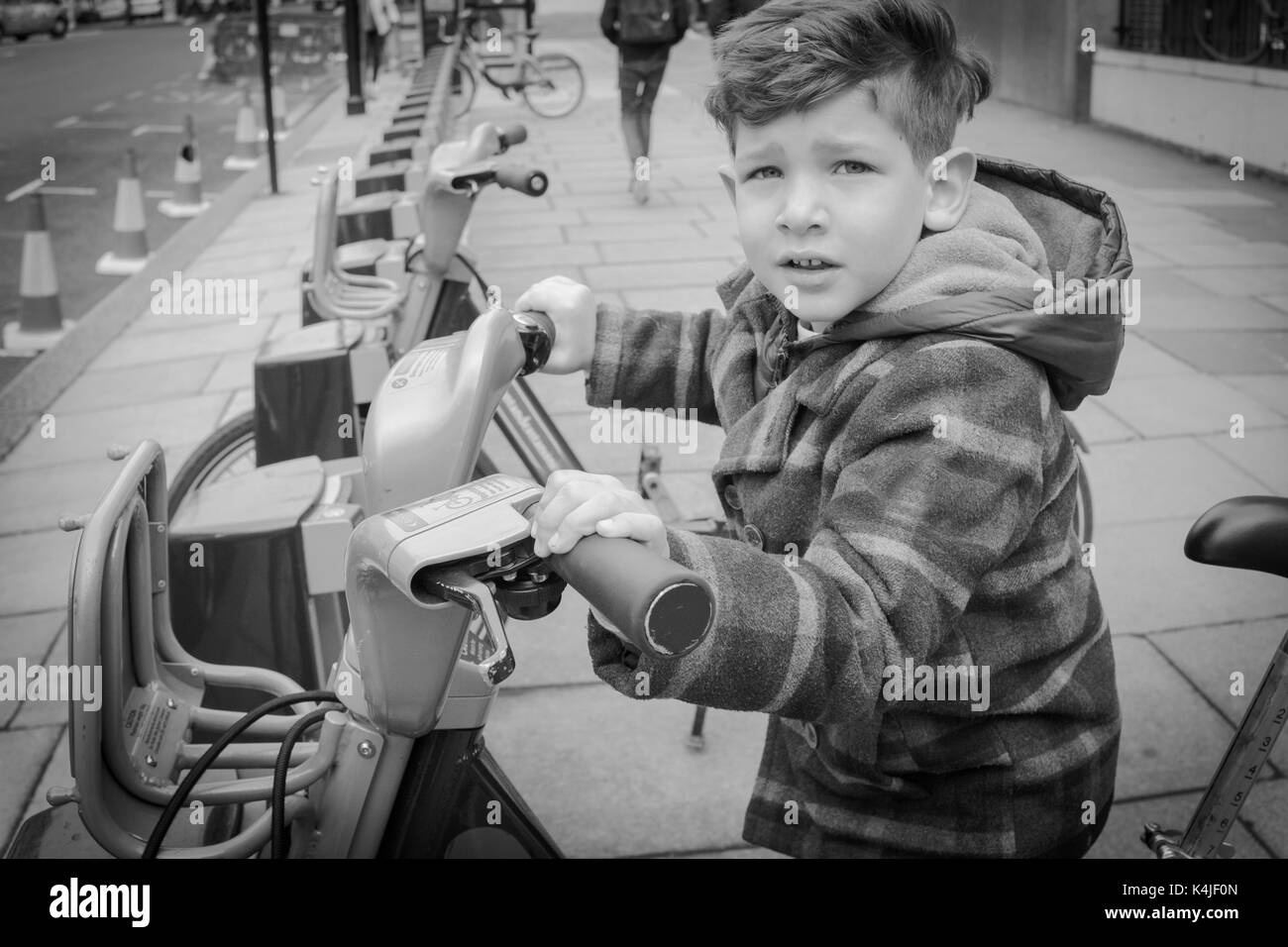 Black and white baby with a public bicycle rental for tourists on a London street Stock Photo