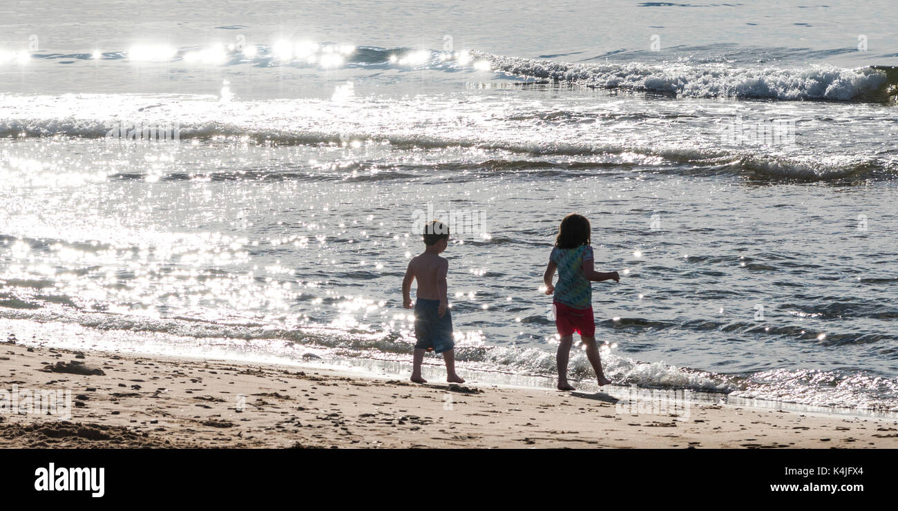Children playing on beach, Inverness Beach, Mabou, Cape Breton Island, Nova Scotia, Canada Stock Photo