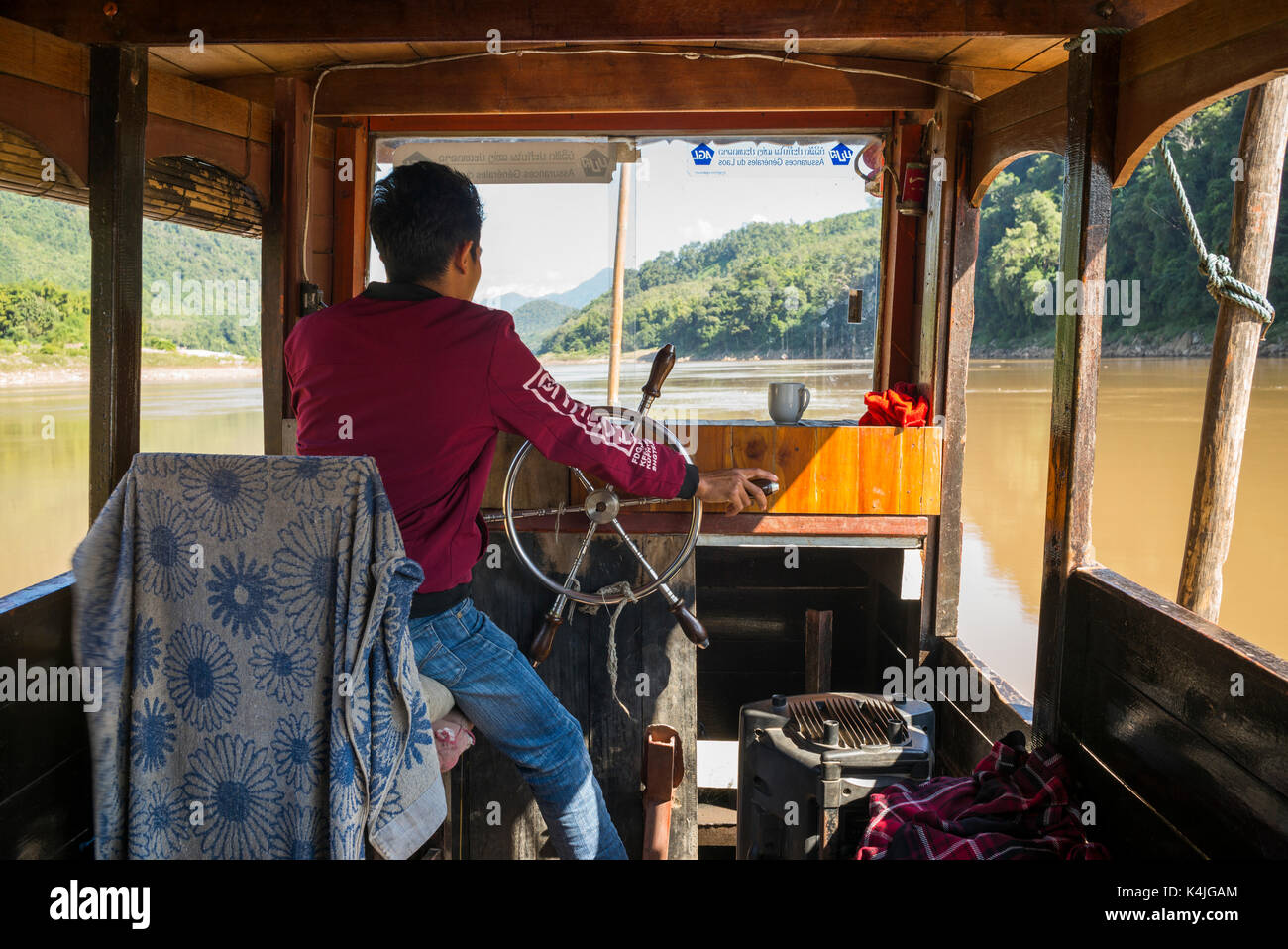 Man steering a boat hi-res stock photography and images - Alamy