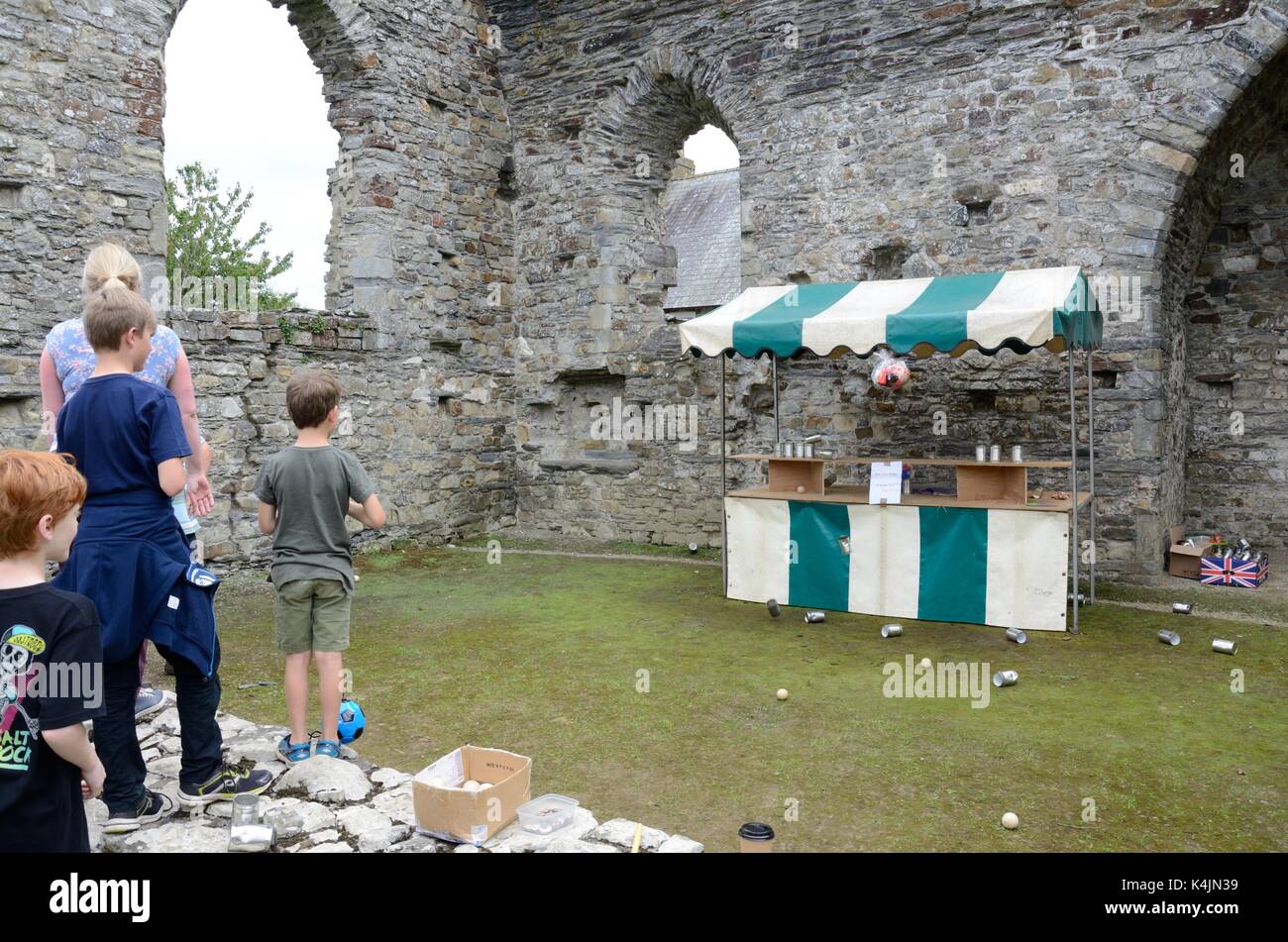 Old fashioned game of throwing balls at cans to win a prize Dogmaels