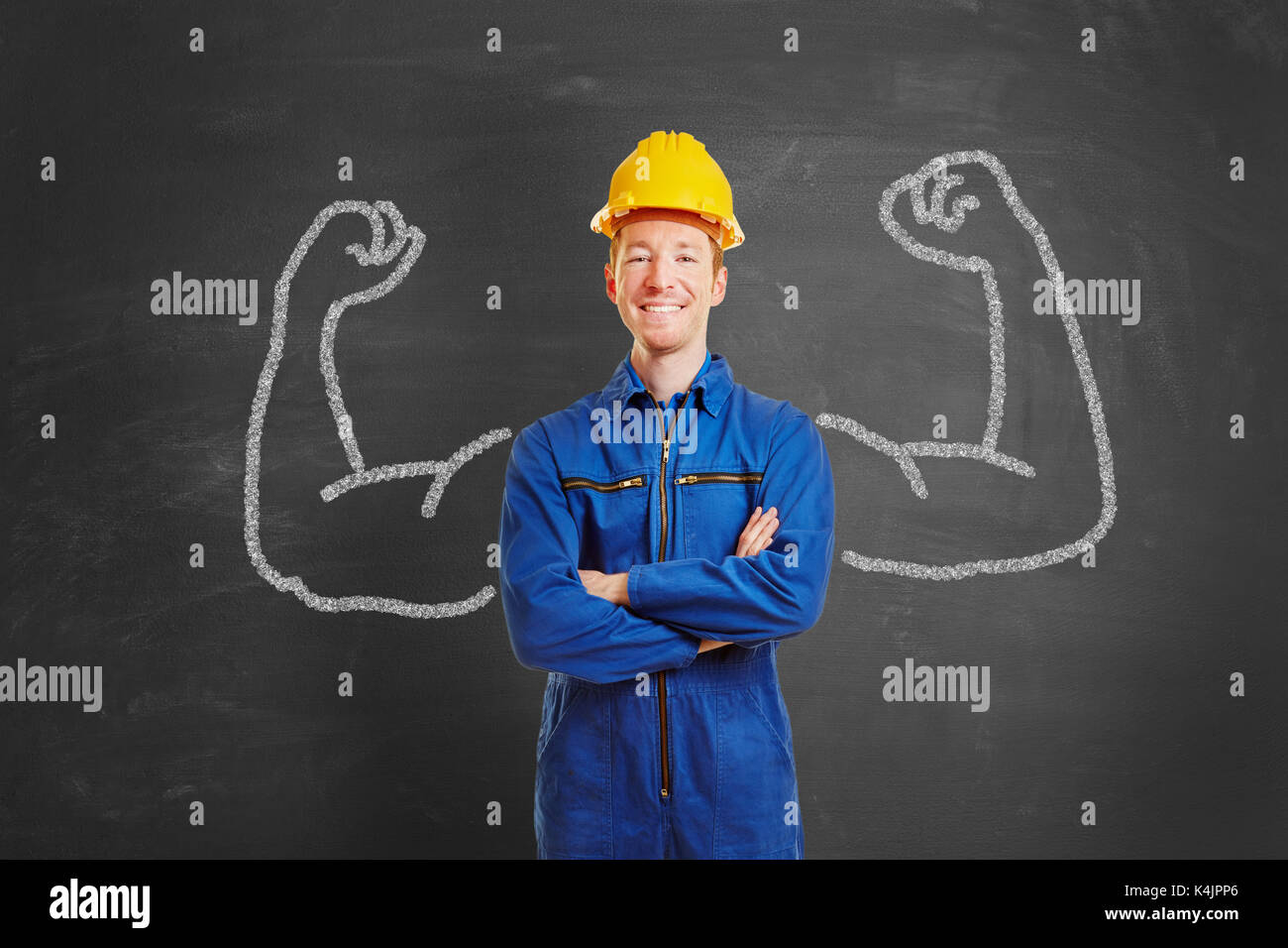 Powerful man as construction worker with chalk muscles on blackboard