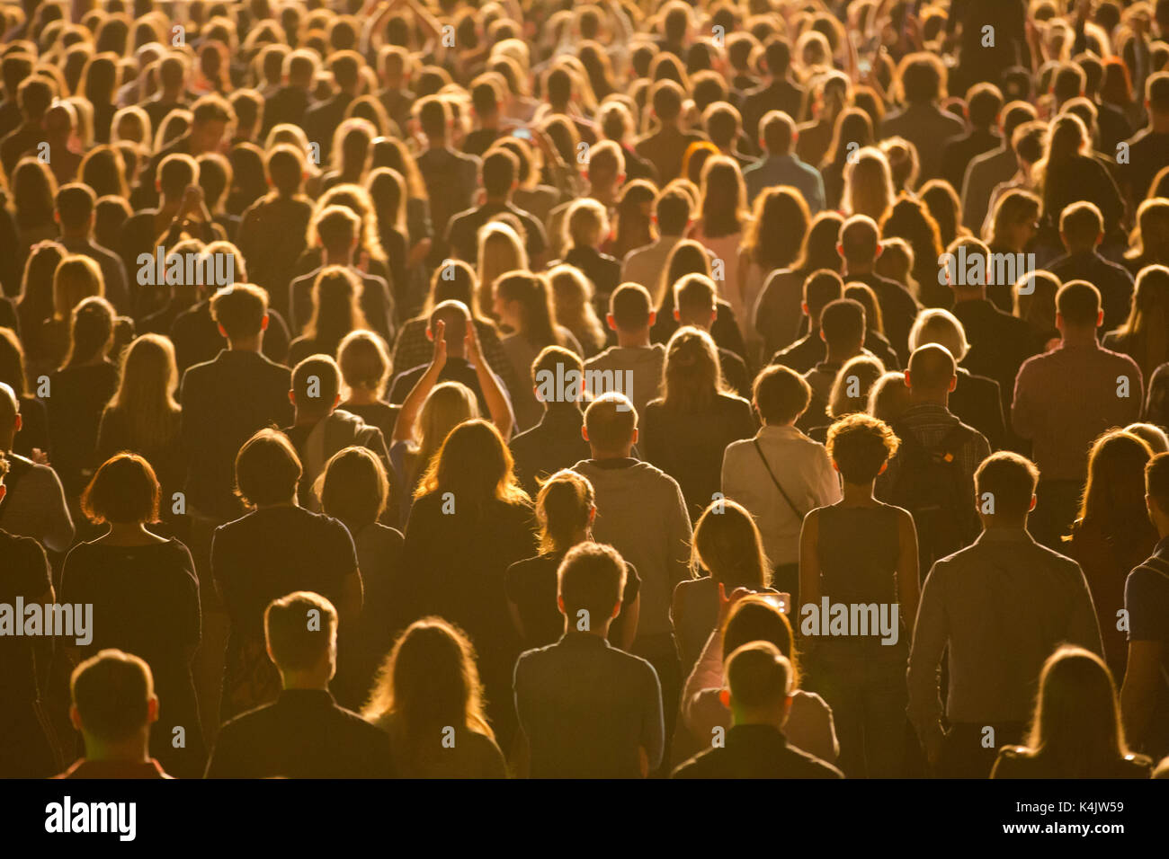 Anonymous crowd of people standing during mass event Stock Photo