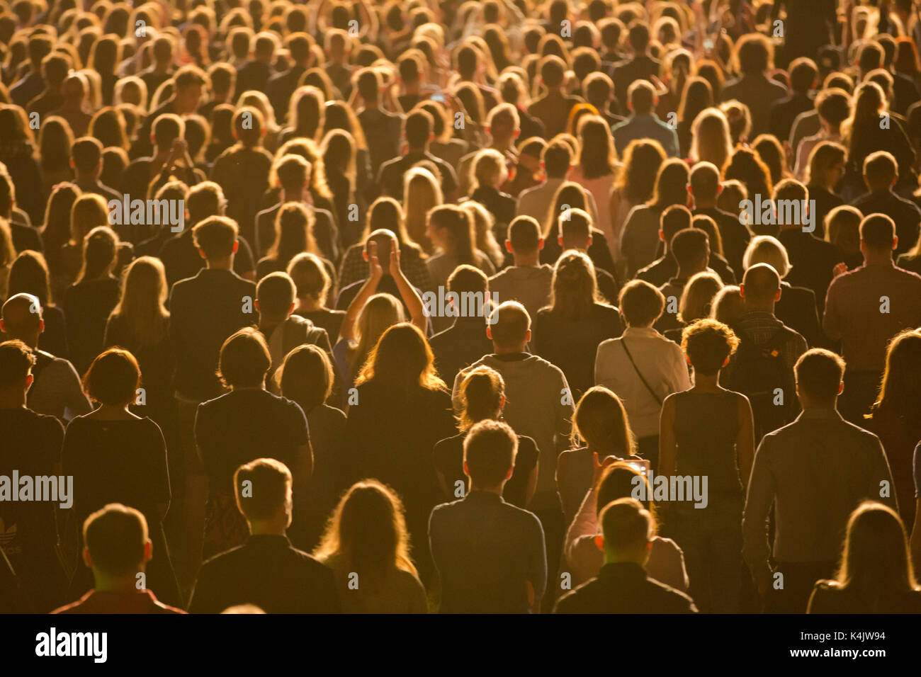 Anonymous crowd of people standing during mass event Stock Photo