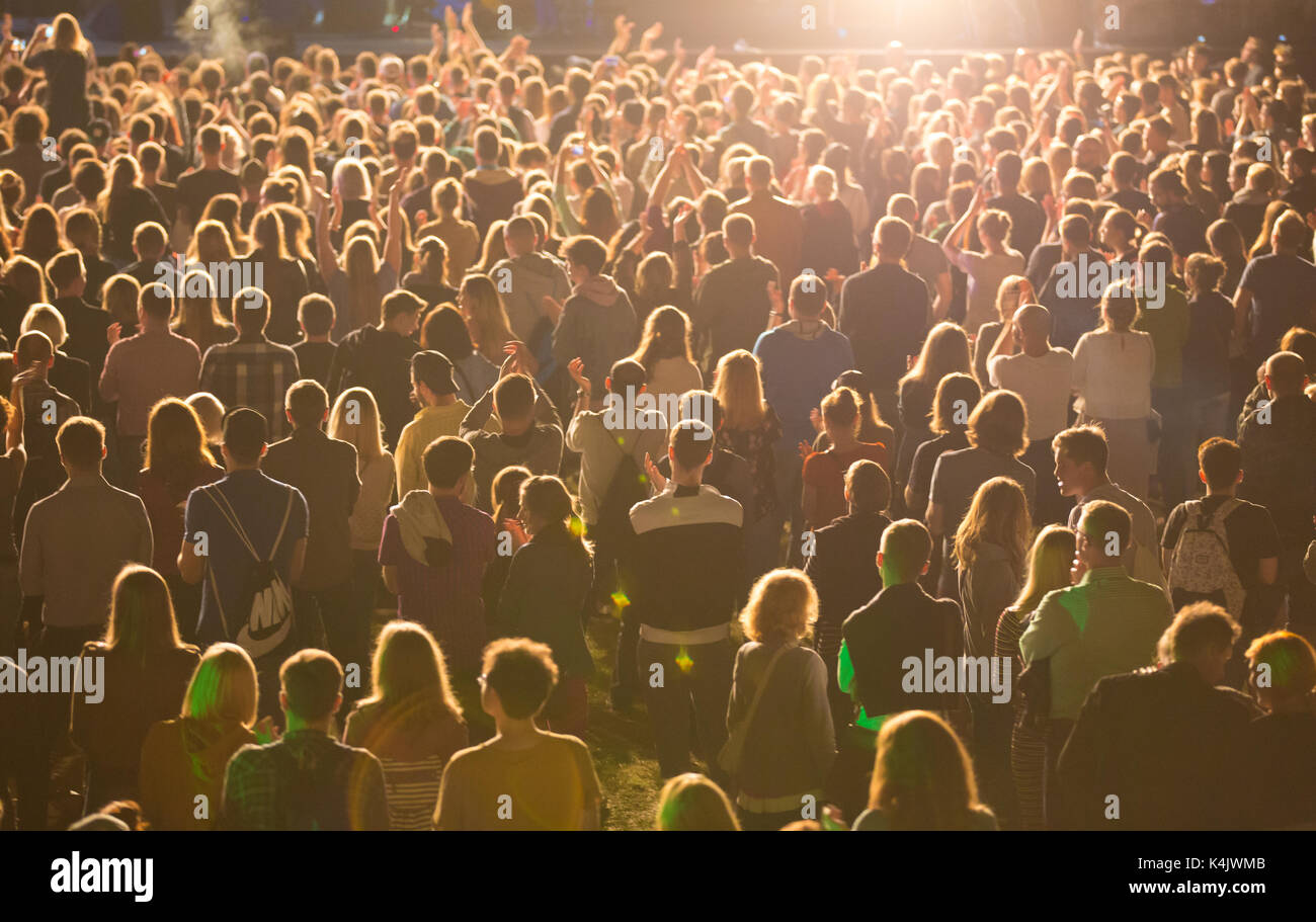 Anonymous crowd of people standing during mass event Stock Photo