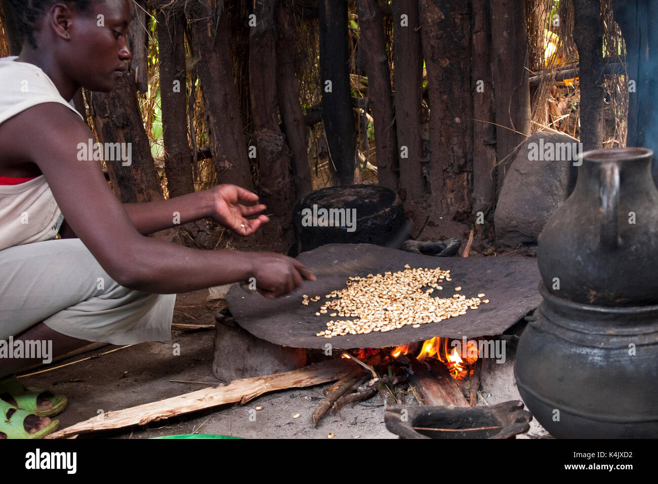 Ethiopian woman roasting coffee beans hires stock photography and