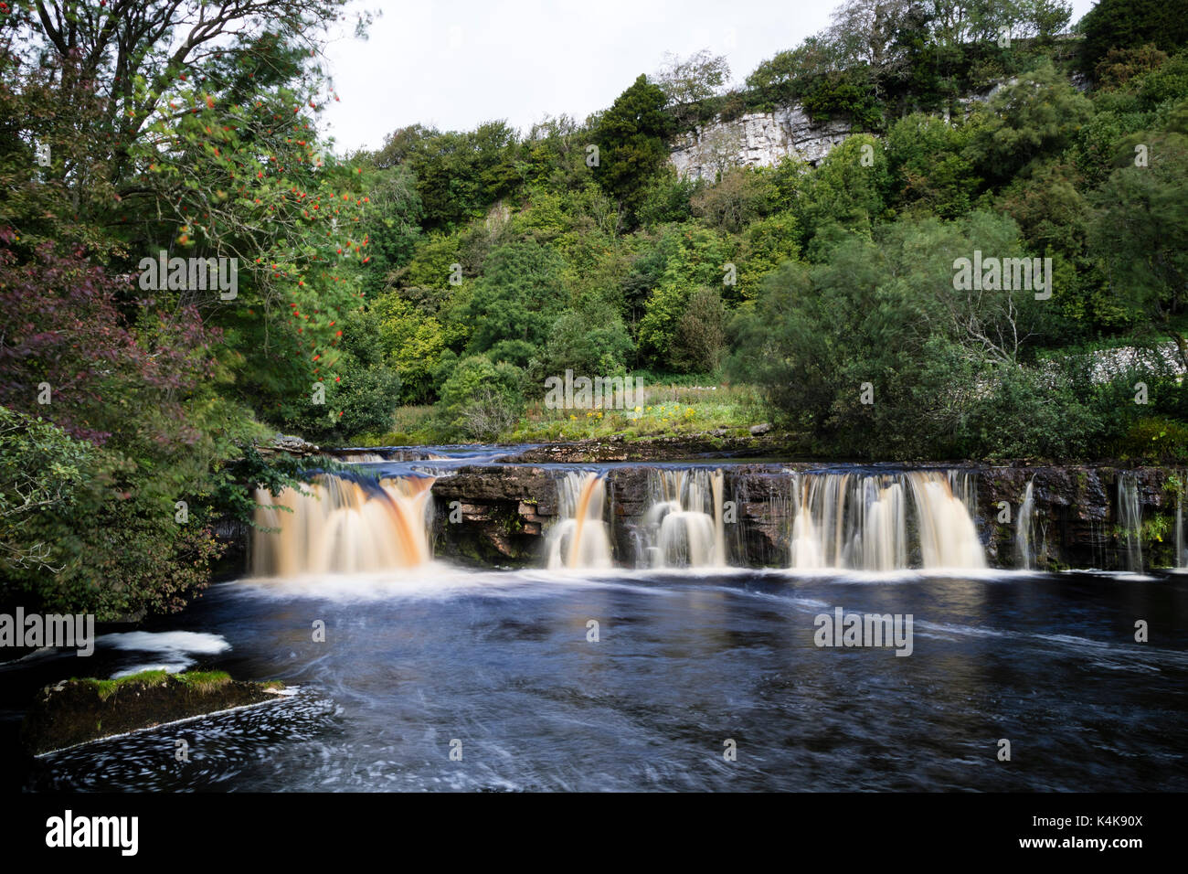 River Swale, Keld, Yorkshire Dales.  Wednesday 6th September 2017. UK Weather.  After a damp start the sun breaks through to illuminate Wain Wath Falls on the River Swale near the village of Keld. Credit: David Forster/Alamy Live News. Stock Photo
