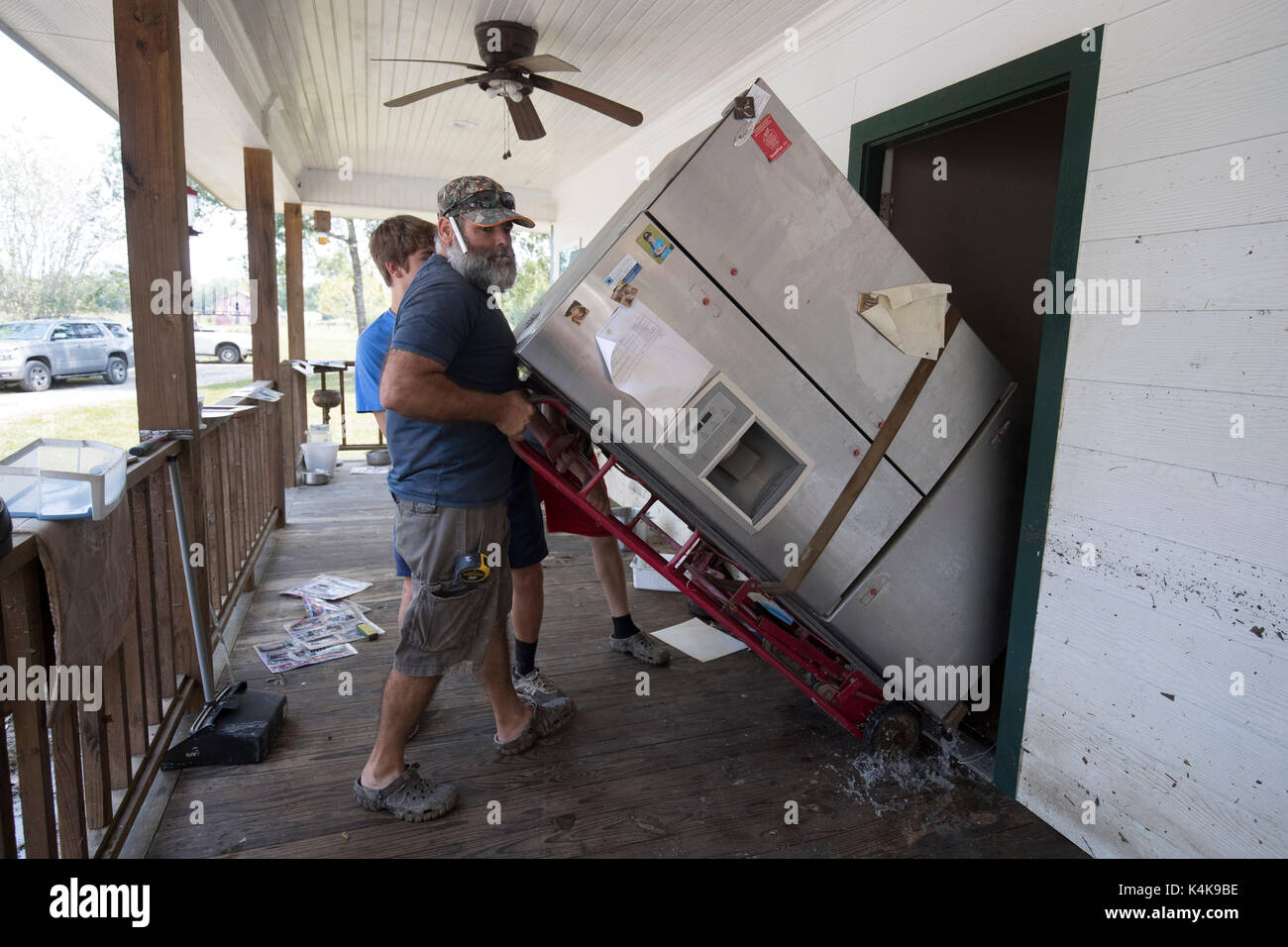 Beaumont, Texas Sept. 6, 2017: Members of the Millican family clean their damaged home off Tram Road as they were just allowed into their homes today nine days after Hurricane Harvey decimated the area. Credit: Bob Daemmrich/Alamy Live News Stock Photo