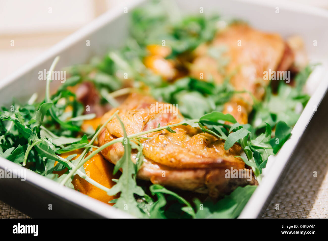 Cooked Duck Legs In Oven With Rocket Salad And Citrus Sauce Stock Photo