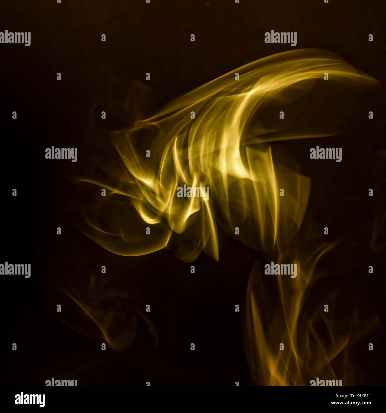 Smoke, yellow colored, black background Stock Photo