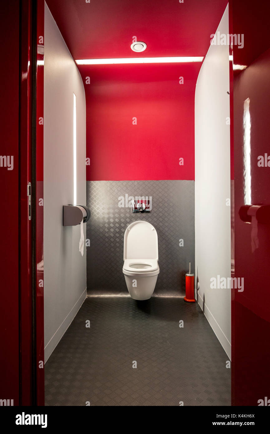 Modern water closet in red and gray nicely illuminated Stock Photo