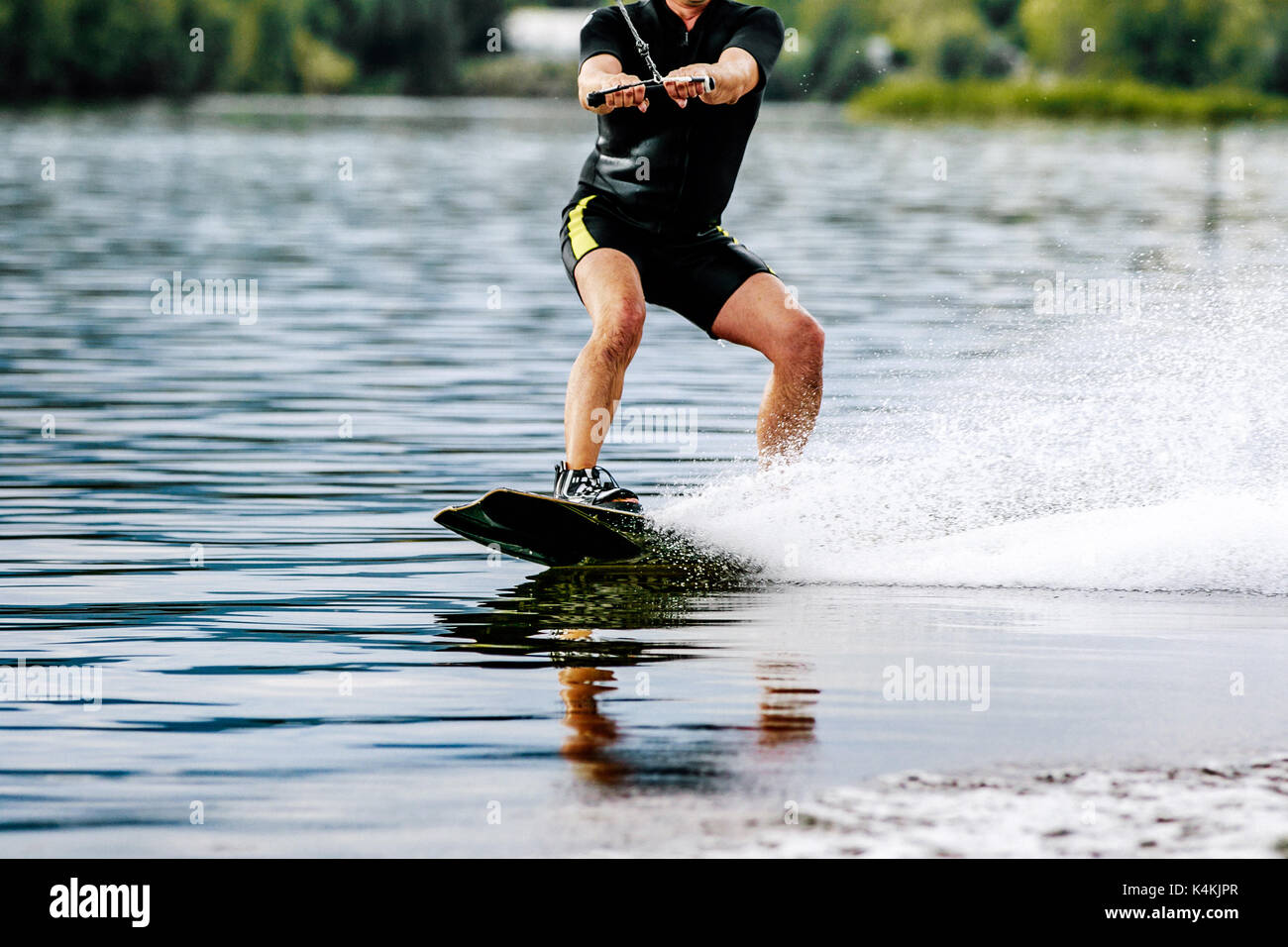 extreme sports man rides a wakeboard on lake Stock Photo