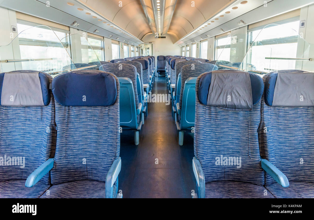 Empty rail passenger carriage seat rows with dimishing perspective Stock Photo