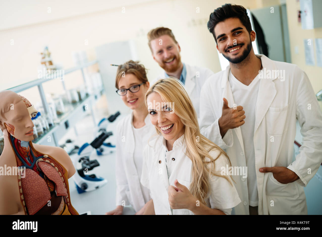 Students of medicine examining anatomical model in classroom Stock Photo