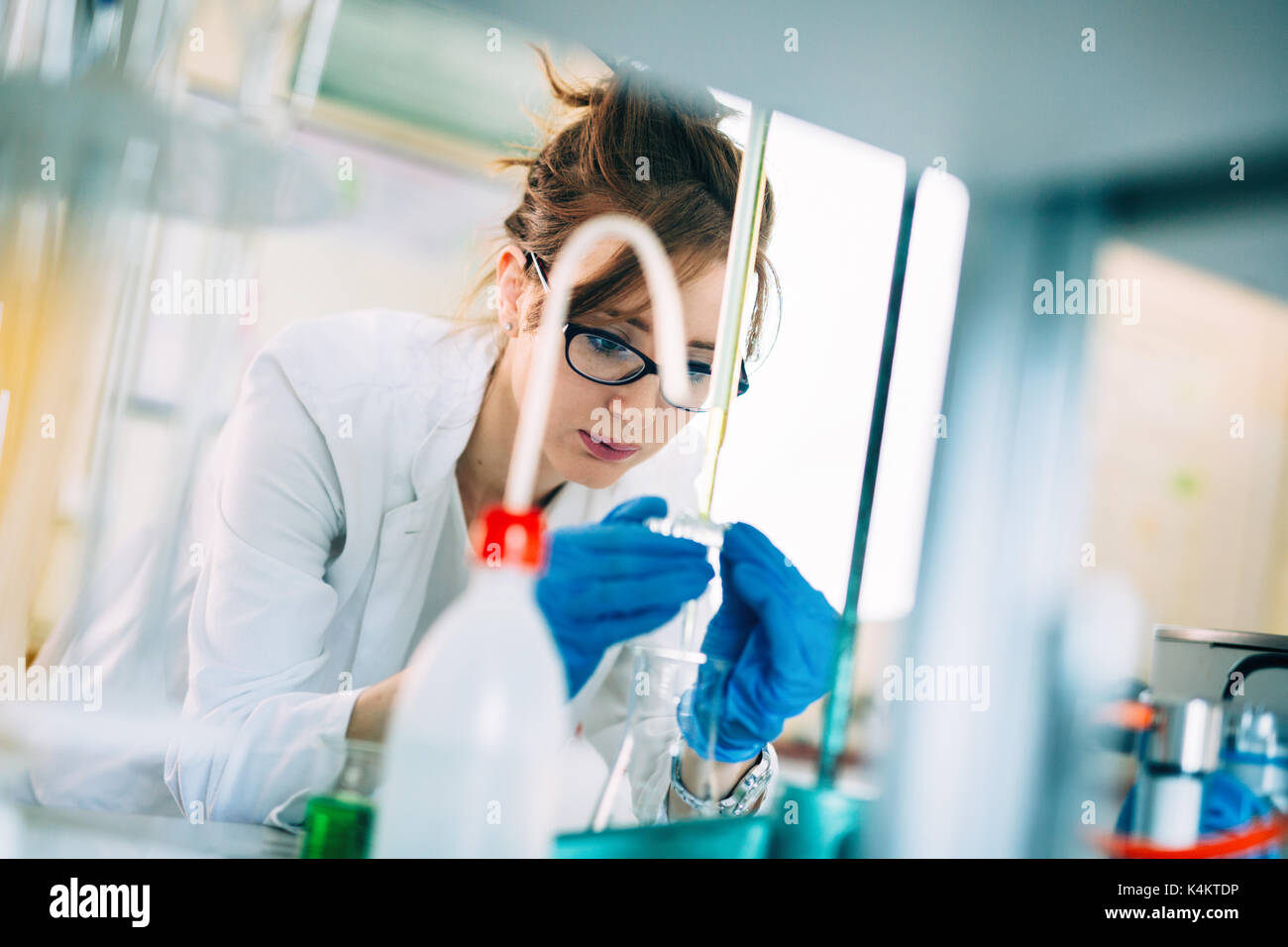Attractive student of chemistry working in laboratory Stock Photo