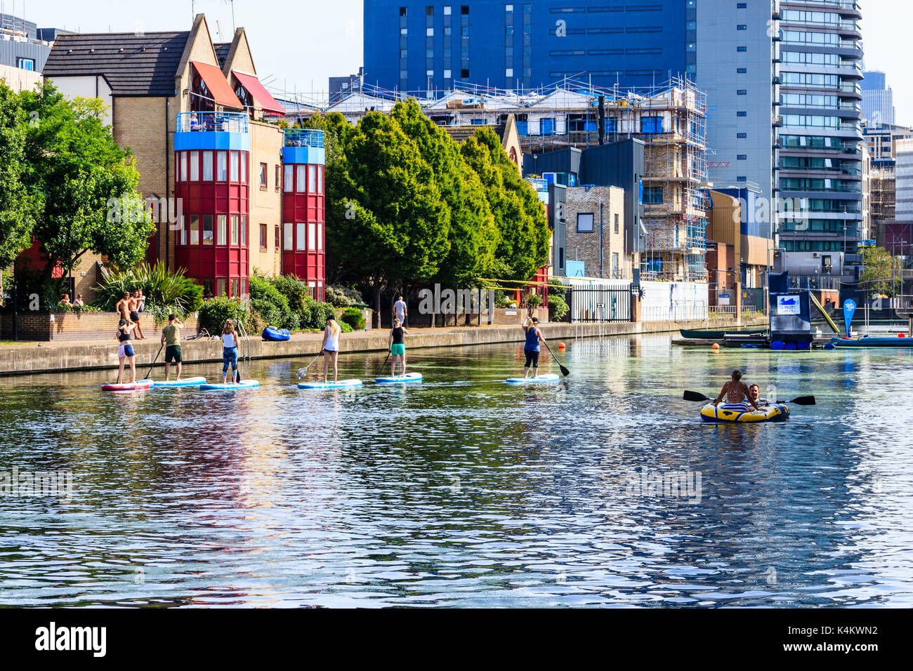 Paddleboarders in City Road Basin cooling off as temperatures rise, Regent's Canal, Islington, London, UK Stock Photo