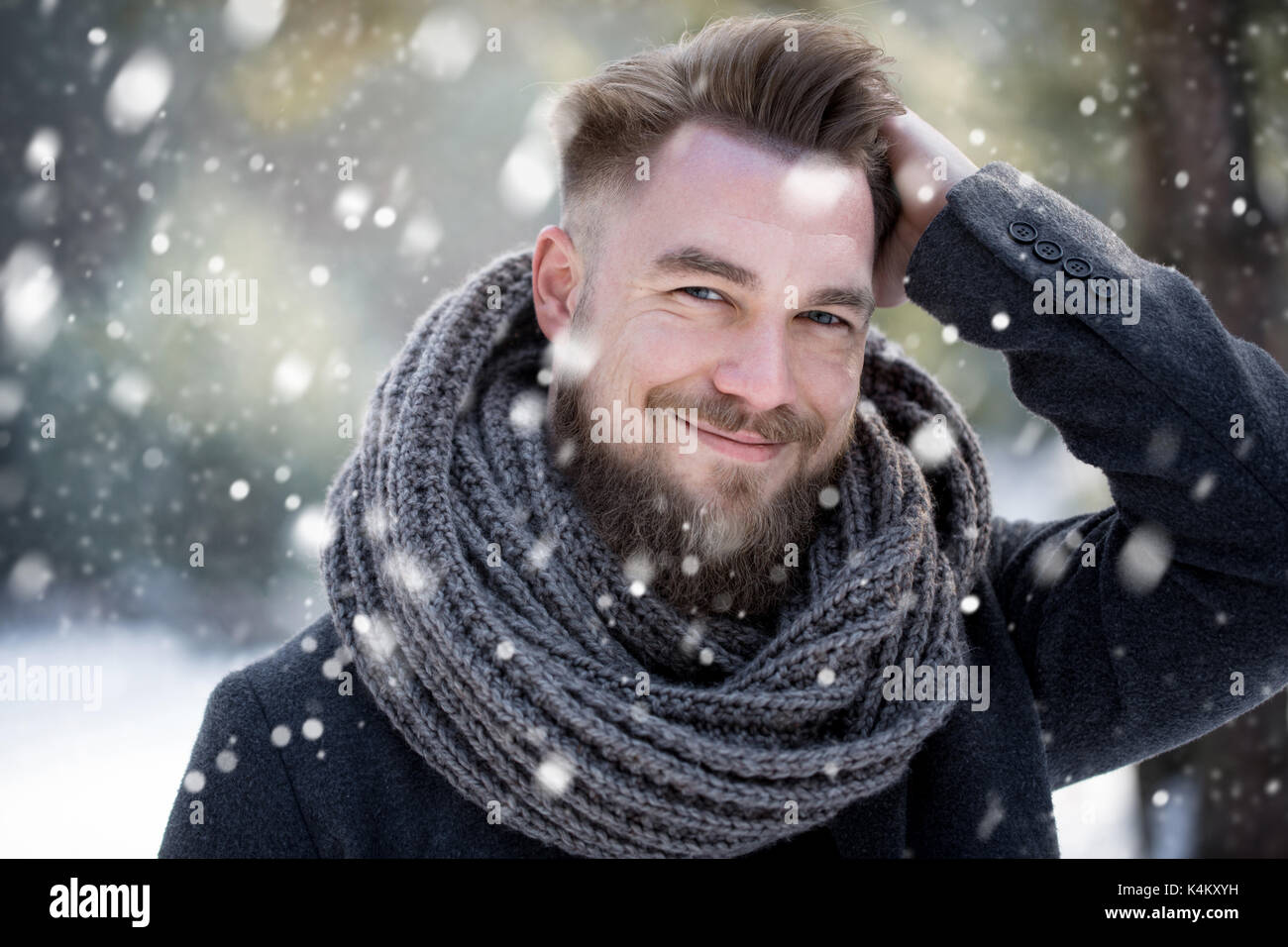 Man combing his hair in winter while snowing Stock Photo
