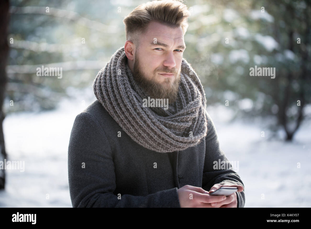 Serious man texting on a biting frost Stock Photo