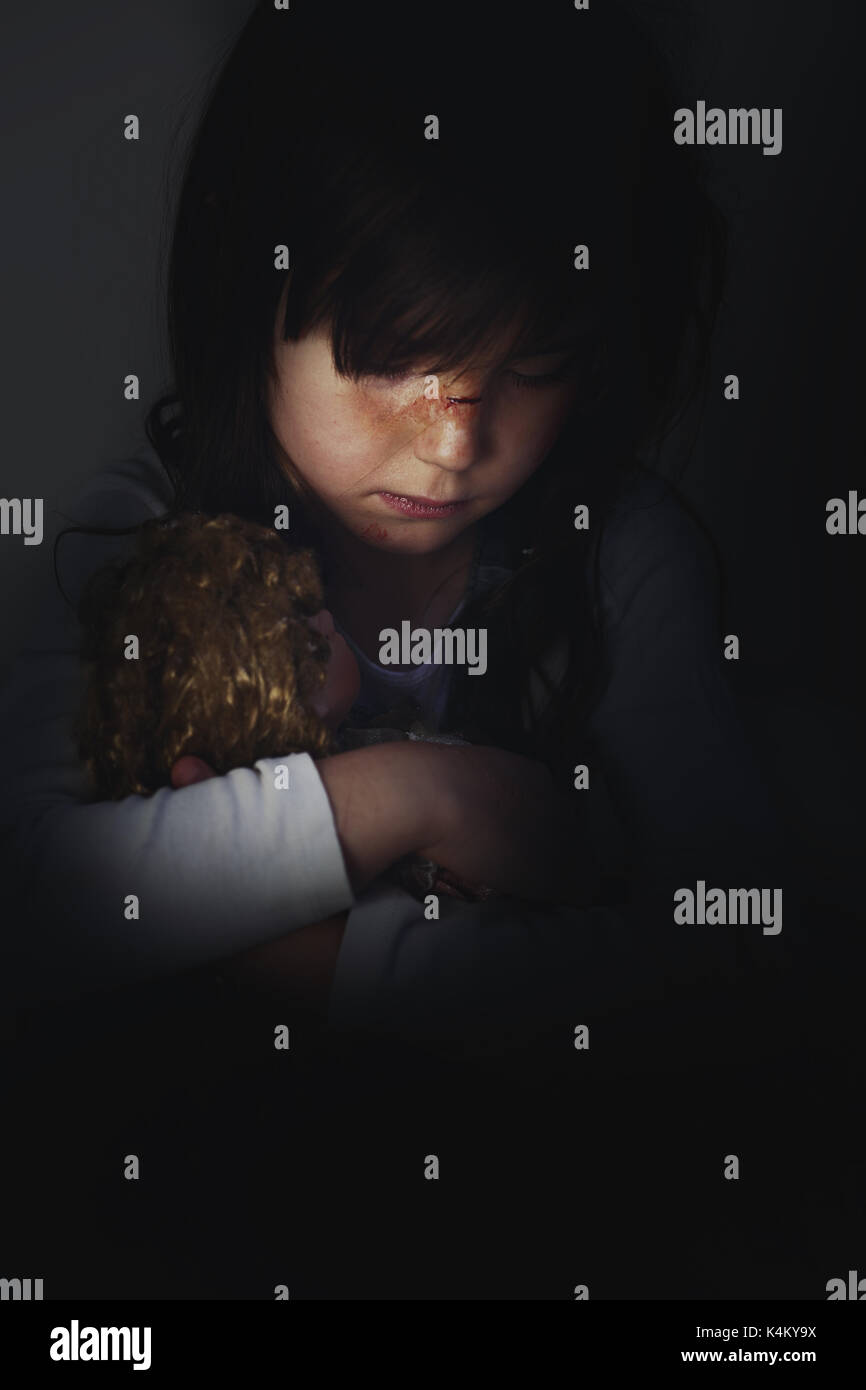 Frightened young girl in a pathological family Stock Photo