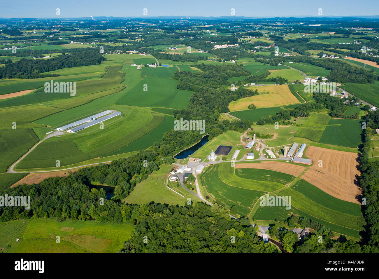 AERIAL VIEW OF FARM WITH CONTOURED FIELDS ALONG HILLSIDE, PENNSYLVANIA