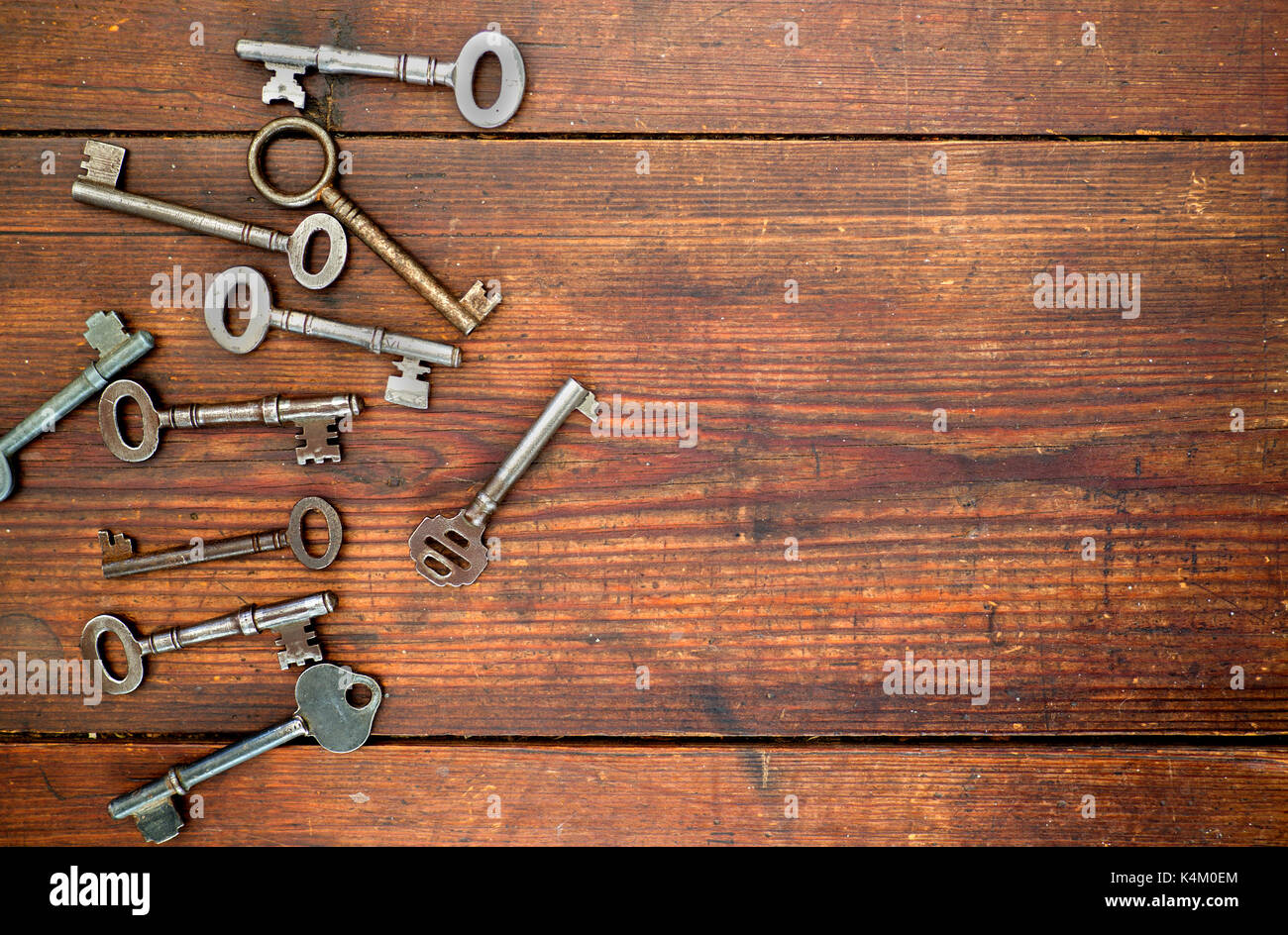 Old keys on old wooden background Stock Photo