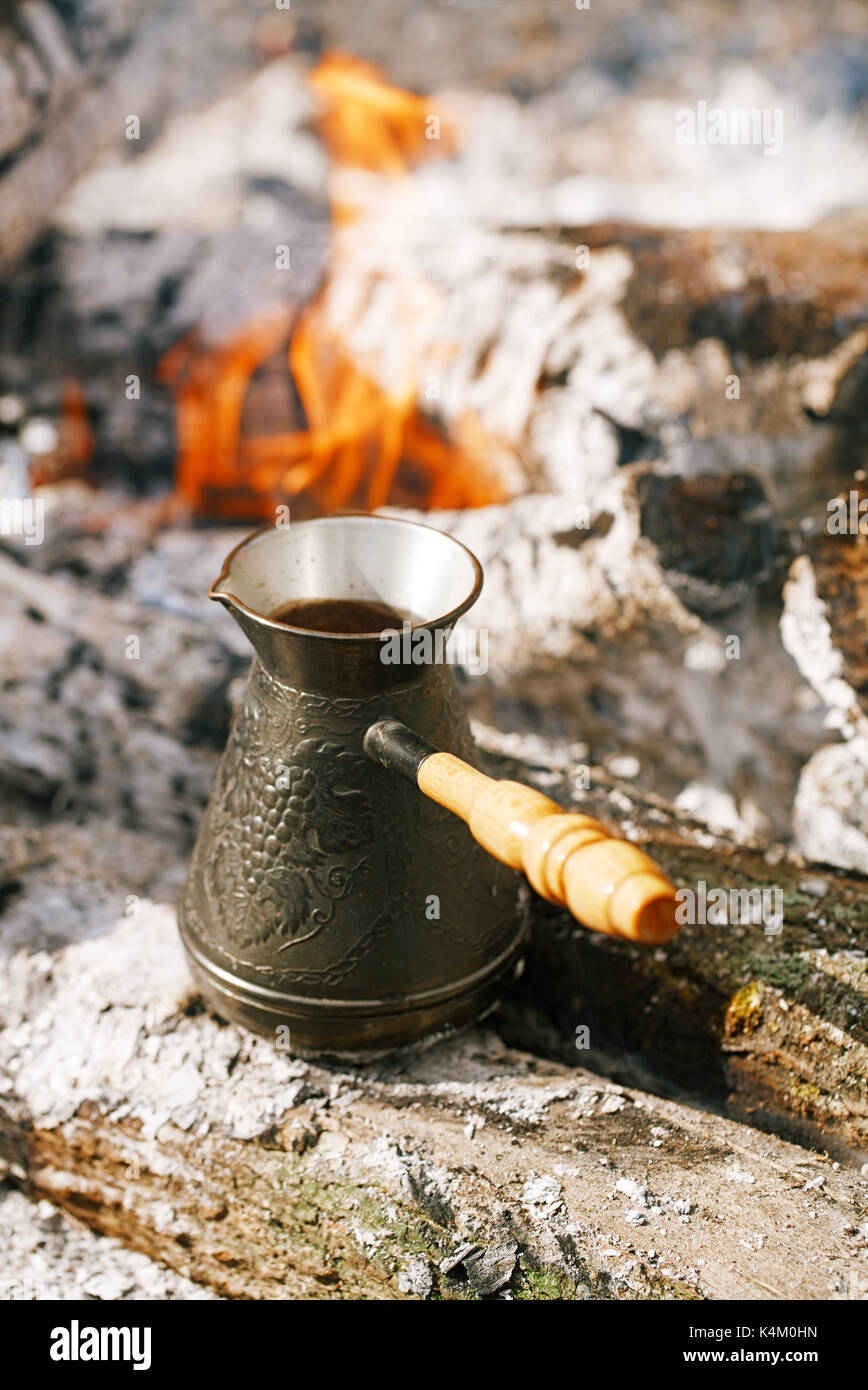 Making coffee in the fireplace on camping or hiking in the nature Stock Photo Alamy