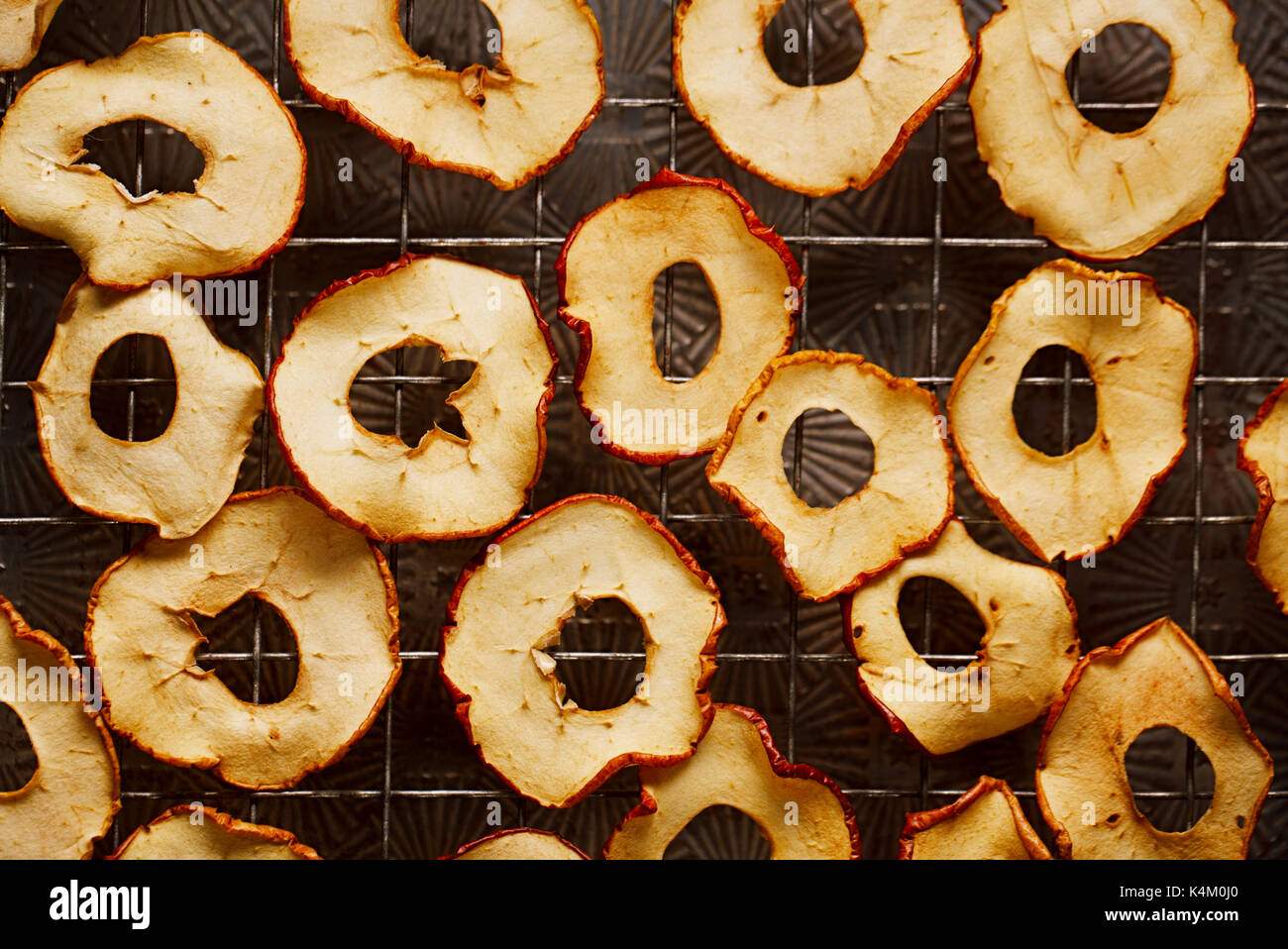 Dried apple slices drying with dark metal backdrop Stock Photo
