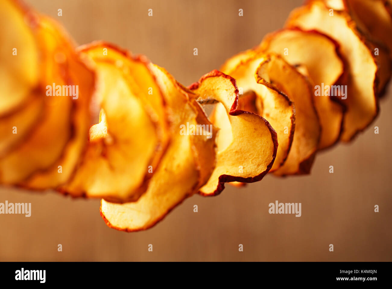 Dried apple slices and wooden backdrop Stock Photo